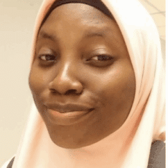 Anisat Ahmed smiling at the camera against a white background.